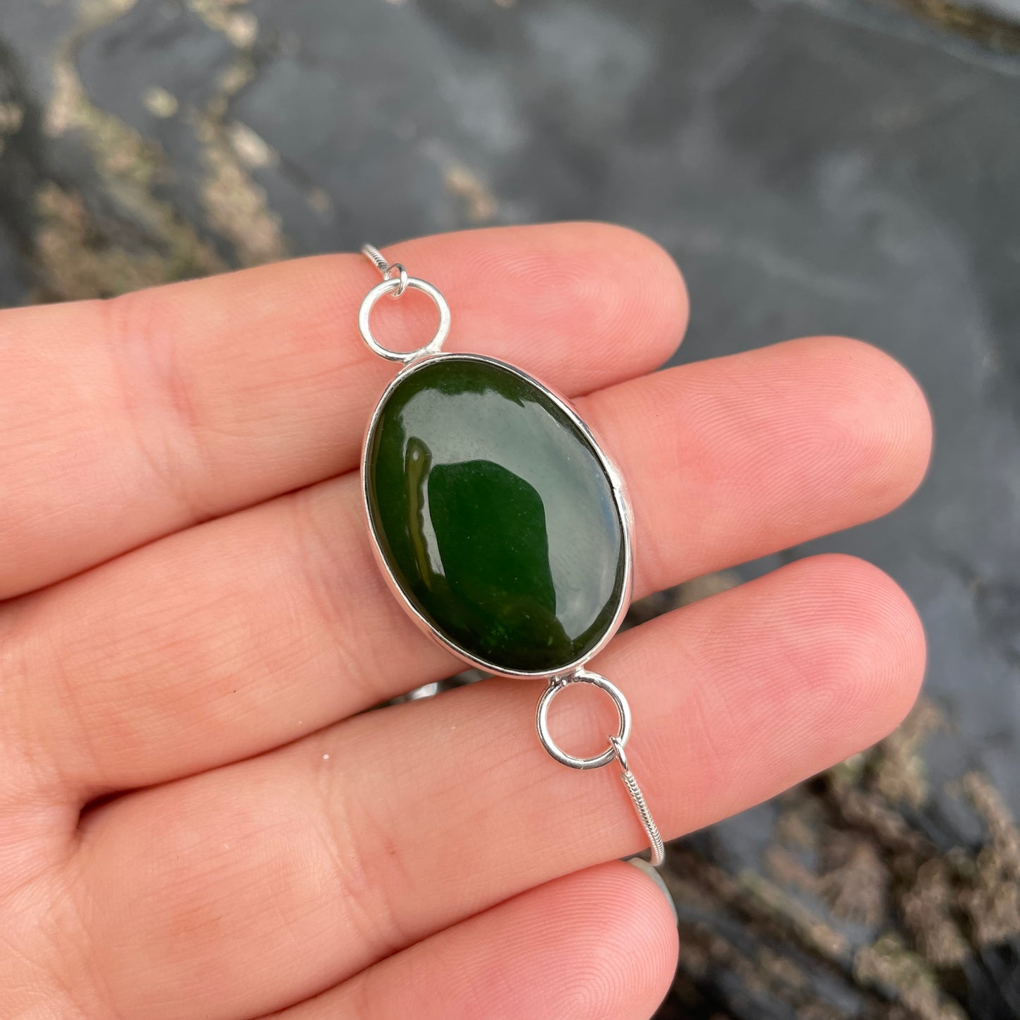 Adjustable sterling silver North Coast bracelet with green stone